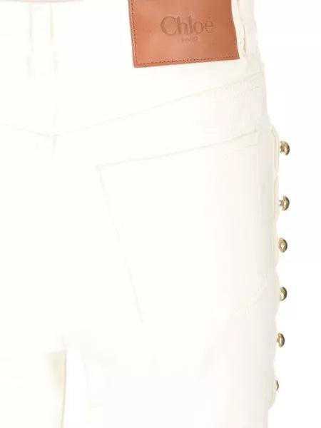 Jeans crop con borchie