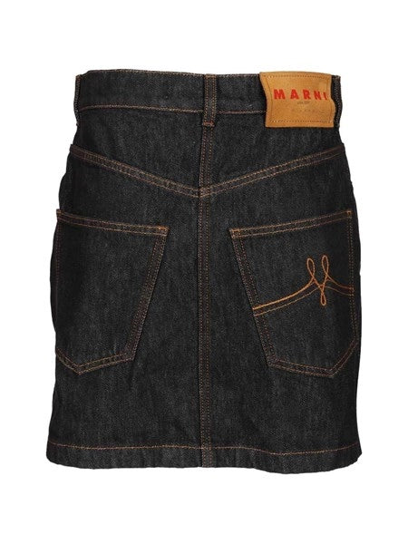 Gonna in denim nero con applicazioni a forma di margherita