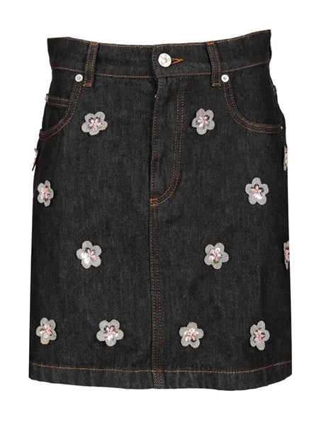 Gonna in denim nero con applicazioni a forma di margherita